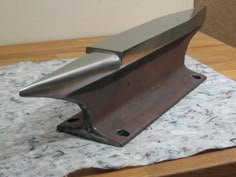 a metal object sitting on top of a wooden table