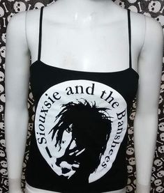 This is a black sleeveless Siouxsie and the Banshees cropped tank top.This has a Siouxsie image screen printed on the front. 95% cotton/ 5% SpandexThese are handmade screenprinted and slightly vary from the photo. Please feel free to email me any questions. Thanks for looking.Due to an influx of incorrect addresses if a package is returned,  you must pay the shipping cost to resend the item to you.I do not do exchanges and I do not take returns unless the item is damaged. I thoroughly check each Emo Black Top For Festival, Black Summer Cosplay Top, Gothic Tank Top For Streetwear, Fitted Graphic Print Tank Top For Alternative Fashion, Fitted Alternative Vest Top, Fitted Alternative Style Vest Top, Black Punk Crop Top For Cosplay, Fitted Gothic Tank Top For Streetwear, Fitted Emo Crop Top For Alternative Fashion