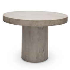 a round concrete table sitting on top of a white floor