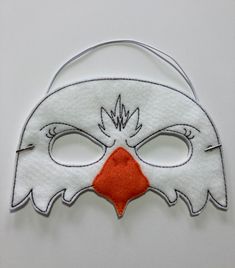 "Eagle Masks. Great for dramatic play/dress-up. Fun mask for Halloween or Cos Play. These masks would make a fun party favor or fun addition to a themed birthday party. You could pair them with your favorite book for a fun gift. Need a larger quantity than what I have listed? Message me. I can usually accommodate larger orders. These masks are made from felt. The details are machine embroidered. The masks include a 13\" elastic strap. This size typically fits from age 3 to small adult. This mask Novelty White Masks For Halloween, Halloween Themed Party Masks And Prosthetics, Themed Eye Mask For Costume Party, Carnival And Halloween Costume Mask, Themed Masquerade Mask For Halloween, White Novelty Costume Accessories For Halloween, White Novelty Halloween Masks, Halloween Novelty White Masks, Novelty White Halloween Masks