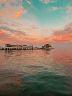 the water is calm and clear as the sun sets