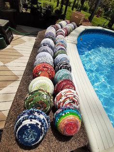 a row of bowls sitting next to a swimming pool