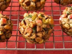 several muffins on a cooling rack with leaves and nuts in the middle, ready to be eaten