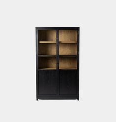 a black bookcase with wooden shelves and glass doors on the front, against a white background