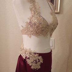 a mannequin wearing a red skirt with gold beading on the top and bottom