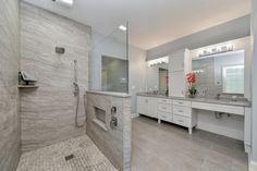 a large bathroom with two sinks and a walk in shower