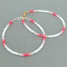 This pink summer seed bead bracelet has been lovingly made using good quality colourful 3mm glass Miyuki and Preciosa seed beads in pinks and white. Available with either 2mm silver or gold Miyuki seed beads to highlight. Threaded on strong stainless steel 7 strand Tiger Tail wire and finished with silver / gold plated wire guardians, a trigger clasp and optional extender chain. Matching necklace available on request. Matching Anklet available on request. More colours and designs can be found at Cute Handmade Bracelets Beads, Design For Bracelet, Bracelets With Glass Beads, Beaded Bracelets And Necklaces, Seed Bead Bracelets For Men, Small Beaded Bracelets Ideas, Bracelet Ideas With Small Beads, Matching Seed Bead Bracelets, Small Beads Ideas