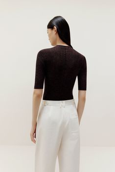 Don’t think twice, just toss this on for instant, effortless style! Our Half Sleeve Sweater is knit from irresistibly soft lightweight wool, making it the perfect top and layering piece. Details Materials & Care Shipping & Returns • Made from Merino wool – naturally warm and breathable with a glossy sheen.• A stylish fine-knit top featuring an elegant mock neck• Half sleeves hit right at the elbow for a super flattering cut.• Tailored for a streamlined fit for easy layering. Size M is 22.8" in l Fitted Knit Top For Layering, Fine Knit Fitted Top For Fall, Chic Pointelle Knit Tops For Fall, Fitted Textured Knit Top, Stretch Textured Knit Tops For Layering, Winter Fine Knit Fitted Top, Textured Knit Turtleneck Top For Layering, Fine Knit Fitted Top For Workwear, Chic Fine Knit Viscose Top