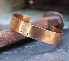 "Our bronze cuff is hand forged from rich jewelers bronze. Your date of choice is stamped by hand on to your bracelet. Cuffs are hammered for texture and then aged in an organic solution to give a warm, rich patina. Bronze is the traditional gift for the 8th and 19th anniversary. *SIZING* The circumference of each cuff is the size in inches plus a 1.25\" to 1.5\" gap. To get the size measure the wrist and compare it to the total in inches of the cuff sizes. For example: Size small is 6.25\" with 19th Anniversary Gifts, Bracelet Cuffs, Date Bracelet, Roman Numerals Dates, Bronze Anniversary Gifts, 19th Anniversary, 8th Wedding Anniversary, Bronze Anniversary, Mothers Bracelet