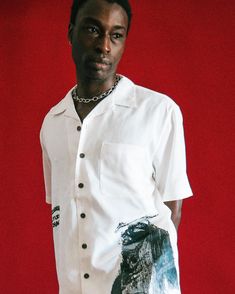 Step into a realm where grunge-inspired aesthetics meet refined elegance with our Solitude Button Up shirt – an exceptional fusion of high-end luxury and streetwear fashion that defies conventions and redefines contemporary style. Crafted from a unique 5.75-ounce blend of 75% poly and 25% rayon, this shirt offers a luxurious and lightweight feel that drapes elegantly on your body. The stain-release finish adds a practical touch, ensuring that your shirt maintains its impeccable appearance wear a Luxury Summer Shirt With Graphic Print, Luxury Graphic Print Shirt For Summer, Designer Collared Tops For Streetwear, Urban Collared Shirt For Summer, Designer Short Sleeve Shirt For Streetwear, Relaxed Fit Shirt With Button Closure For Streetwear, Luxury Relaxed Fit Collared Shirt, Luxury Collared Shirt With Relaxed Fit, Relaxed Fit Tops With Button Closure For Streetwear