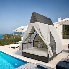 an outdoor bed next to a swimming pool