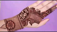 a woman's hand with henna tattoos on it