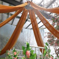 the inside of a greenhouse with flowers and greenery