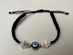 Evil's eye black cord bracelet with hamsa palm for protection and luck.Free shipping only to UK. Black Spiritual Friendship Bracelets With Evil Eye, Spiritual Black Friendship Bracelets With Evil Eye, Spiritual Black Evil Eye Friendship Bracelets, Spiritual Black Friendship Bracelet With Evil Eye, Adjustable Black Bohemian Evil Eye Bracelet, Black Bohemian Friendship Bracelets With Evil Eye, Black Bracelet, Cord Bracelet, Black Bracelets