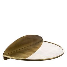 a gold leaf shaped tray with two white plates on the bottom and one black plate in the middle