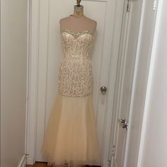 Beautiful Cream Colored Strapless Gown With Tulle Skirt. Gold And Cream Beads With Ribbon Sewn Into Top - So Unique And Elegant. Nwt Never Worn Champagne Strapless Gown For Prom, Strapless Champagne Gown For Prom, Strapless Wedding Dress With Sweep Train For Prom, Champagne Strapless Fitted Gown, Strapless Embellished Evening Dress For Prom, Embellished Strapless Evening Dress For Prom, Embellished Tulle Strapless Dress For Prom, Embellished Tulle Strapless Dress For Wedding, Strapless Dress With Detachable Train For Prom