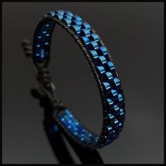 This handmade stylish blue hematite  bracelet will perfectly fit with your formal style. It is a perfect gift for you and all your loved one for all special days such as birthday, valentine's day, father's day, anniversary etc. Wrap is durable 1,5 mm polyester black rope. For closure of our high quality bracelet we used zamak alloys button with 2 optional closure buttonhole. Please kindly check your wrist size according to the picture of measurement instruction and order the same size.  All our designs prepare by hand according to the your given sizes with love. We offer 8 size option between 5.9-8.7 inches (15-22 cm) , please DM us to demand different wrist size. Used materials; 2*6 mm two hole pig nose bluehematite 1.5 mm black korean rope 1 cm zamak alloys button ☆ABOUT US☆ https://www. Modern Adjustable Blue Braided Bracelets, Modern Adjustable Blue Braided Bracelet, Modern Blue Adjustable Bracelets, Modern Adjustable Blue Bracelets, Elegant Blue Leather Bracelet For Gift, Modern Blue Beaded Bracelets For Gift, Modern Blue Beaded Bracelets As Gift, Modern Blue Bracelet For Gift, Handmade Modern Blue Beaded Bracelets