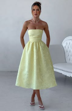 A dress to wear all seasons, Saoirse in Lemon is cut from our prettiest floral jacquard fabric in a midi length with super full skirt lined with tulle for extra volume. This strapless style has boning in the bodice for a cinched waist, with pleating and gathered detailing. The look is complete with lace up back. Wear with a pointed heel and chic hair up.Ã‚Â 



Colour: Lemon.

Floral jacquard fabric.

Fully lined.

Full skirt with tulle for volume.

Pleated bodice.

Boning in bodice.

Gathered d Yellow Dresses For Wedding, Cute Midi Dresses Classy, Formal Casual Outfits Women Dress, Provence Wedding Guest Dress, Jacquard Midi Dress, Colourful Dress Outfit, Wedding Guest Yellow Dress, Wedding Guest Dress Unique, Two Fabric Dress