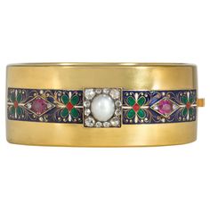 An antique ruby, diamond, pearl, and enamel Holbeinesque cuff bracelet centered by a pearl in a rose-cut diamond surround and flanked by rectangular enameled elements, each centered by rubies and diamonds set in a rhombus, in 15k gold. England. Inner circumference: 6 1/2" Width: 1" Please do not hesitate to request photos of additional details or of this vibrant piece worn by a live model. Luxury Vintage Cuff Bracelet With Cabochon, Rubies And Diamonds, Live Model, Victorian Gold, White And Orange, Gold Cuffs, Enamel Bracelet, Ruby Diamond, Gold Enamel