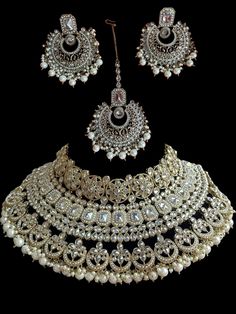 This bridal set comes in a gorgeous white beads and bronze gold plating. The set is lightweight and can easily be worn separately for a lighter and simple look. The finishing is done in gold and is completely handmade with intricate work. Only one piece in stock! Gold Chandbali Bridal Accessories Hand Set, Gold Chandbali Hand Set Bridal Accessories, Gold Sets With Intricate Design For Reception, Ceremonial Kundan Jewelry With Gold Beads, Gold Bridal Accessories With Intricate Design For Marriage, Gold-plated Beaded Jewelry For Wedding, Traditional White Jewelry For Marriage, Festive White Bridal Earrings With Elegant Design, Gold Beads Jewelry For Wedding