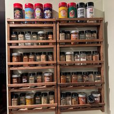 a wooden spice rack filled with lots of different types of spices