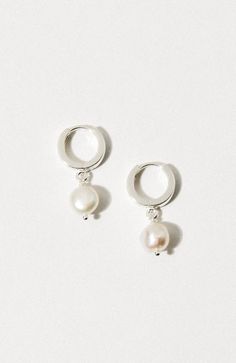 Sterling silver huggie earrings adorned with authentic, organically shaped freshwater pearls. The pearl was regarded by ancient Greeks as a symbol of love and devotion, thus was used for romantic customs and ceremonies. Love is Nirvana.Clasp measures 1/2 inch long with click closure / Sterling SilverFresh Water Pearl measures 1/2 inchSize and shape slightly varies Silver Huggie Earrings, Huggie Earrings Silver, Unique Symbols, Fresh Water Pearl, Special Jewelry, Symbol Of Love, Huggie Earrings, Pearl Size, Love Symbols