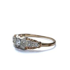 an antique diamond ring on a white background