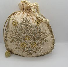 ethnic traditional indian wedding gota patti zardosi embroider potli bag handbag for woman | potli bag for return gift | indian wedding giftPackage Contents: 1Size: 10" x 8"Designed with the heart, this beautiful Potli or batawa bag are eye catchy and made of premium material.Key Features:Ark Work.This potli is good match with both Indian and western outfits and are superb for wedding and festive parties.This would be best complement to your designer saree, lenhga or any other kind of dress.This Gold Handwork Potli Bag, Gold Zari Work Potli Bag For Gift, Gold Potli Bag With Dori Work, Gold Pouch Potli Bag With Dori Work, Gold Potli Bag For Navratri, Gold Potli Bag For Navratri Gift, Traditional Potli Bag With Dori Work For Festive Occasions, Traditional Gold Potli Bag With Zari Work, Gold Zari Work Potli Bag For Navratri