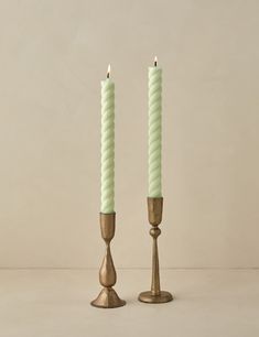 two candles are standing next to each other