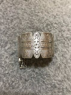 A beautiful old Berber silver bracelet from Morocco. The surface of the bangle has been finely hand-etched with a design combining lines, and the surface as well as interior have both obtained a rich patina from wear and usage. It opens and closes with a pin. Inner diameter : 5,8cm Width : 3,7cm Weight : 83,8g Bohemian Silver Cuff Bracelet With Intricate Design, Silver Bohemian Bracelets With Intricate Design, Silver Bohemian Bracelet With Intricate Design, Bohemian Silver Bracelets With Intricate Design, Engraved Bohemian Bangle Jewelry, Bohemian Silver Filigree Bracelets, Bohemian Sterling Silver Bracelet For Ceremonial Occasions, Bohemian Filigree Cuff Bracelet, Bohemian Engraved Antique Silver Cuff Bracelet