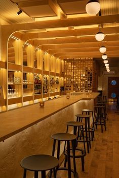 an empty bar with several stools and shelves