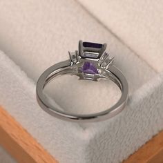 a ring with an amethyst stone in it