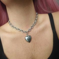 Stunning gothic/punk style chunky broken heart choker necklace in silver 💔  Chunky yet lightweight and comfortable to wear this necklace goes well with any outfit! This necklace is made of 100% stainless Steel so is water resistant and won't tarnish or discolour! Available in various sizes ( necklace shown in photographs measures 15 inches) Width of chain: 12mm Heart pendant measures: 29x26mm Please don't hesitate to contact me with any queries or suggestions 😊  Comes gift wrapped 🖤 Silver Heart Choker With Charm, Silver Heart Charm Choker, Silver Heart Choker With Heart Charm, Metal Heart Charm Choker Necklace, Silver Metal Choker With Heart Pendant, Punk Heart Necklace As A Gift, Punk Style Heart Necklace For Gift, Edgy Heart Pendant Necklace For Valentine's Day, Edgy Heart Charm Jewelry For Valentine's Day