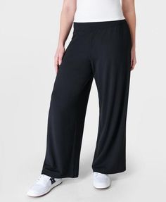 Our super comfortable trousers for luxe lounging. Soft, sustainable fabric made from plant-based modal Lenzing™ yarn. Effortless pull on design and a relaxed wide leg fit. Wear high rise or with the wide waistband folded down. 2 subtle slip pockets at the hips. Rise length for size S: 9" / 23cm. Inseam length: 29" / 73cm.. Model wears size S and is 178cm/5'10"tall. Style Code: SB8238Colour: Black Versatile Wide Leg Pull-on Pants For Loungewear, Versatile Wide Leg Viscose Pants With Elastic Waistband, Versatile Viscose Wide Leg Pants With Elastic Waistband, High-waisted Wide Leg Pants With Elastic 4-way Stretch, Relaxed Fit Wide Leg Pants With Pull-on Style, Versatile 4-way Stretch Sweatpants For Loungewear, Solid Color Wide Leg Pants With Relaxed Fit, Versatile Yoga Pants For Lounging, Sporty Wide Leg Bottoms For Relaxation