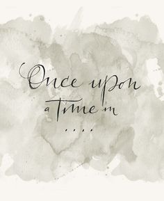 the words once upon a time in black and white ink on a watercolor background