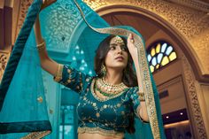 Look stylish in this teal blue 3-piece set, crafted with kumkum silk, lino silk & nylon satin, and heavy net fabric for the blouse, lehenga, and dupatta respectively. Features intricate hand work, zari & sequins embroidery, round neck, regular sleeves, and 10-meter ruffle style flair on the lehenga. The set comes with a dupatta and customizations are available - simply add your measurements during checkout. Dry clean only. No of Set - 3-piece set Color- Teal Blue Blouse Fabric - Kumkum Silk Blou Blue Color Lehenga, Teal Blue Blouse, Satin Lehenga, Silk Lehenga Choli, Indian Lehenga Choli, Lehenga Choli Wedding, Stitched Lehenga, Party Wear Lehenga Choli, Salwar Dress