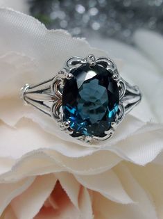 "<>#145  This is a brand new stunning Gothic/Renaissance inspired sterling silver filigree ring. The flawless oval-cut high-quality VVS 3.5ct London blue natural topaz is 11mm (7/16th of an inch) by 9mm (just shy of 3/8\" inch) in dimension... The inside of the band is marked 925 for sterling. This topaz has great color and clarity. Notice the beautiful filigree swirl like the craftsmanship of the silver setting. This is an exquisite rendition of a Gothic design filigree ring.... and is re Intricate Blue Topaz Ring, Silver Filigree Ring With Blue Topaz, Blue Topaz Filigree Ring, Ornate Silver Blue Topaz Jewelry, Blue Topaz Filigree Ring Gift, London Topaz Ring, Filigree Jewelry, Gothic Rings, Sterling Silver Filigree