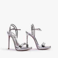 Sleek Metallic Heels With 4-inch Heel, Sleek Metallic Open Heel Shoes, Sleek Metallic High Heels, Sleek Silver Ankle Strap Heels, Modern Metallic Heels With 4-inch Heel, Modern Metallic Heels With Open Heel, Modern Metallic Open Heel Heels, Luxury Metallic Sandals With 4-inch Heel, Sleek Silver Evening Sandals