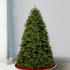 a small christmas tree sitting on top of a white table