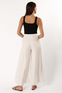 DETAILS   Are you ready to turn heads and show off your style? We've got the perfect pant for you! These wide leg pants are ideal for making a chic statement and will take your wardrobe up a notch. The high waist, front pleating detail, belt loops, and functional pockets add to their stylish appeal.  wide leg style pant  high waisted  elasticised waistband at back  front invisible zip with button close  belt loops  functional pockets  lined  material - 70% rayon / 30% linen    SIZING     model i Chic Solid Color Wide Leg Pants With Elastic Waistband, Chic High Waist Wide Leg Pants With Elastic Waistband, Chic Wide Leg High Waist Pants With Elastic Waistband, Chic Wide Leg Pants With Elastic Waistband, Chic Wide-leg Bottoms For Day Out, Chic Pants With Elastic Waistband For Day Out, Versatile High Waist Wide Leg Pants, Chic Straight Leg Culottes With Elastic Waistband, Versatile High-waisted Wide Leg Pants