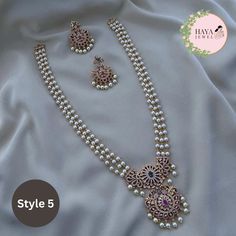 Embrace the timeless elegance of South Indian tradition with this stunning gold-plated haram necklace and earrings set. This exquisite piece features an intricate design adorned with sparkling CZ stones and delicate pearls, reminiscent of the grandeur of ancient temples. The long, layered necklace cascades down your chest, drawing attention to your neckline with its captivating beauty. Crafted with meticulous attention to detail, this set is perfect for: Bridal wear: Add an air of timeless sophistication to your wedding look with this breathtakingly beautiful set. Party wear: Make a statement at any special occasion with this eye-catching piece that is sure to turn heads. Cultural events: Immerse yourself in the rich heritage of South India with this authentic and elegant jewelry set. Feat Gold Perle Necklace, Pearl Necklace Set Indian, Gold Pearl Jewelry Necklace, Pearls Jewelry Indian, Long Necklace Designs, Pearl Haram, Chest Drawing, Long Necklace Indian, Diamond And Pearl Necklace