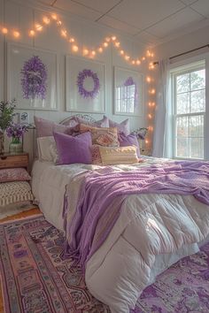 a bedroom with purple and white decor on the walls