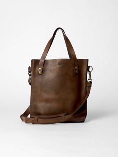 The Tote Bag in vintage brown leather by John Woodbridge in small format 35 x 32 cm with long straps to be worn on the shoulder. - Dimensions : 35 x 32 cm - 2 inside pockets - Available in 1 color vintage brown Everyday Brown Shoulder Bag Briefcase, Vintage Brown Soft Leather Shoulder Bag For Daily Use, Classic Bucket Shoulder Bag With Brass Hardware, Brown Briefcase With Double Handle, Vintage Soft Leather Everyday Bag, Brown Briefcase With Double Handle And Handle Drop, Brown Crossbody Briefcase For Everyday Use, Vintage Brown Crossbody Bag For Everyday, Vintage Brown Everyday Crossbody Bag