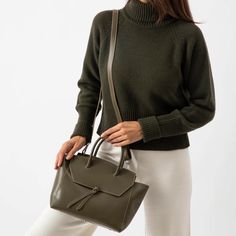 This stylish and effortless medium size bag is handcrafted in Italy with premium quality leather, making it lightweight yet durable. It's easy to clean and maintain, so it'll stay looking as good as new for years to come. With its timeless design and classic look, this tote bag will be a timeless addition to your wardrobe. Whether you're heading out for the day, or going away for the weekend, this midi purse is sure to turn heads wherever you go. Modern Olive Shoulder Bag For Everyday, Chic Olive Leather Shoulder Bag, Modern Olive Shoulder Bag, Olive Leather Tote Shoulder Bag, Olive Tote Bag With Leather Handles, Leather Making, Medium Sized Bags, Leather Pouch, Black Print