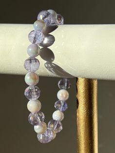 Royal Purple Glass and Seashell Bracelet - Daughter of the King Jewelry Discover your inner royalty with this stunning lilac bracelet, inspired by Proverbs 31:22. Crafted with exquisite glass and iridescent seashell beads, this piece embodies the elegance and strength of a true daughter of the King. Let this delicate accessory elevate your style and serve as a daily reminder of your divine heritage.  Key features: Biblical inspiration: Proverbs 31, Christian jewelry, faith jewelry Elegant design Lavender Crystal Bracelet With 8mm Beads As Gift, Lavender 8mm Beads Bracelet Gift, Elegant Hypoallergenic Purple Beaded Bracelets, Spiritual Iridescent Bracelets For Gift, Lavender Beaded Bracelets With 8mm Beads For Gift, Elegant Lavender Bracelets With Faceted Beads, Spiritual Iridescent Bracelets As Gift, Elegant Lavender Beaded Bracelets With Faceted Beads, Adjustable Lavender Spiritual Bracelets