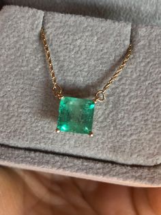 Square Cut Colombian Emerald Solitaire Pendant Drop Necklace in 14K Yellow Gold. This necklace features a medium green natural Colombian emerald, clarity: SI, Weight 1.68 Carat, Square Shaped 7.0mm x 7.0mm prong-style setting. Wheat Chain 14K Yellow Gold 16.5" total pendant necklace weight 2.55g Emeralds typically contain inclusions that are visible to the unaided eye. Because of this, trade members and some consumers understand and accept the presence of inclusions in emeralds. Eye-clean emeralds are especially valuable because they’re so rare. Emerald inclusions are often described as looking mossy or garden-like. They’re sometimes called "jardin,” which is French for garden. Formal Hallmarked Emerald Necklace, Elegant Hallmarked Green Emerald Necklace, Formal Emerald Necklaces With Diamond Cut, Luxury Green Emerald Necklace For Anniversary, Luxury Green Pendant Necklace, Classic Green Emerald Necklace In 14k Gold, Luxury Emerald Square Pendant Necklace, Luxury Green Emerald Necklaces, Formal Green Emerald Gemstone Necklace