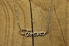 Forever necklace This pretty silver Forever pendant necklace would make a great gift for a girlfriend.  The charm and chain are both made from stainless steel.   The necklace features a stunning stainless steel 'Forever' pendant on a stainless steel chain.  Measurements: 'Forever' charm: 33 x 10mm The chain measures 17 inches (extendable to 20 inches). How's it packed? Your item will be packaged in a purple organza bag. Your order will then be shipped in a padded envelope. Forever necklace, silver forever necklace, forever pendant, forever pendant necklace, forever charm, forever gift, forever, anniversary gift, anniversary present, forever, anniversary, gift, wife gift, girlfriend gift, infinity necklace, infinity gift Forever Necklace, Necklace Infinity, Forever Gifts, Gift Girlfriend, Infinity Necklace, Anniversary Present, Wife Gift, Girlfriend Gift, Organza Bags