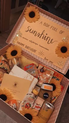 a box full of sunshine is sitting on the ground