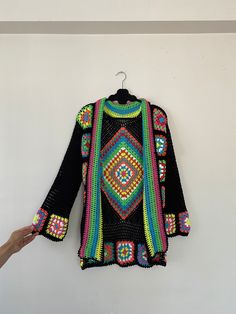 in stock! Granny square black boho style patchwork cardigan is combined with inspiration from the rainbow. :) The yarn used in the cardigan is cotton. It will be a unique gift to have a wonderful product for your loved ones for their birthdays and special occasions! Be the sparkle of your festivals and parties! Cardigan Sizes Width 105 cm / 41.3 inch Height 70 cm / 27.5 inches Model Size: 178 cm / 5 Feet 10.79 Inches / 63 kg - 138 lb. washing information It can be washed in the hand wash program Bohemian Multicolor Long Sleeve Cardigan, Bohemian Long Sleeve Patchwork Sweater, Bohemian Long Sleeve Multicolor Cardigan, Multicolor Long Sleeve Bohemian Cardigan, Granny Square Long Sleeve Cardigan For Festivals, Granny Square Long Sleeve Festival Cardigan, Long Sleeve Granny Square Cardigan For Festival, Festival Long Sleeve Granny Square Cardigan, Bohemian Multicolor Cardigan For Festivals