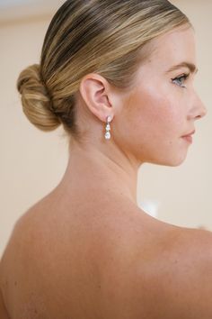 a woman with very large earrings on her back